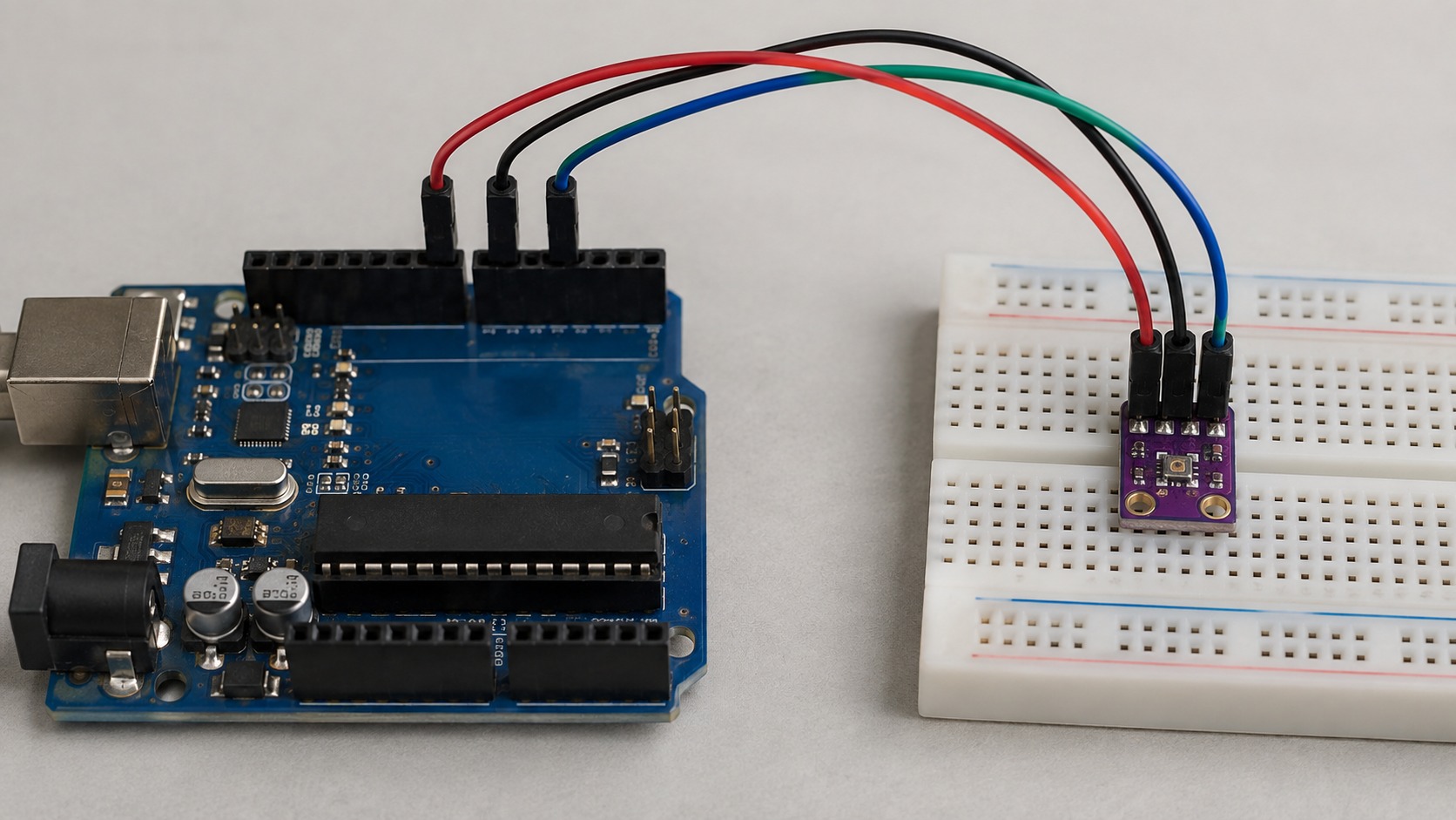 45-degree bench photograph of an Arduino Uno, breadboard and a four-wire SHT30 sensor connection